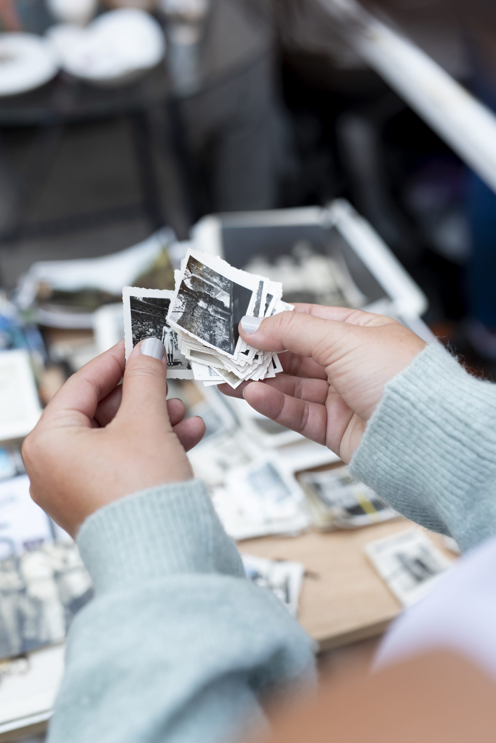 hands holding old photos second hand market